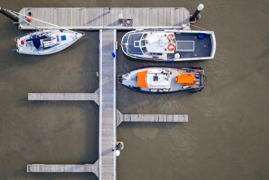 boats, including the dredging vessel innovation, berthed at a marina